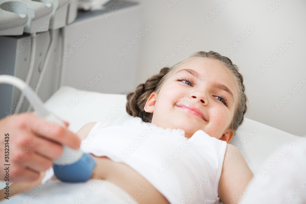 Medical exam little girl by ultrasound equipment