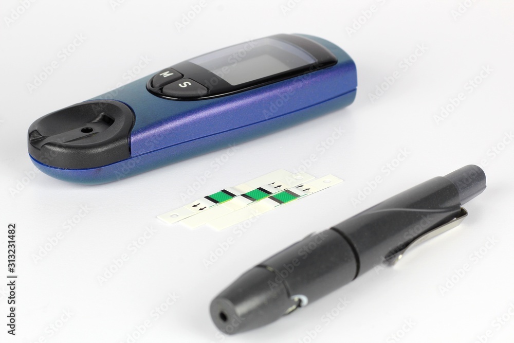 Glucometer. A device for measuring blood sugar levels. Test strips on a uniform background. Glucometer. A device for measuring blood sugar levels. Test strips on a uniform background.