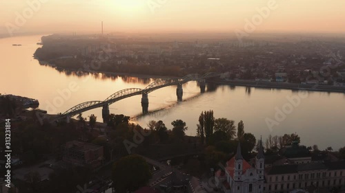 Beautiful wide angle Aerial view of a Bridge over Danube river with Komarno city in background, sunset, Slovakia, Hungary, Europe photo