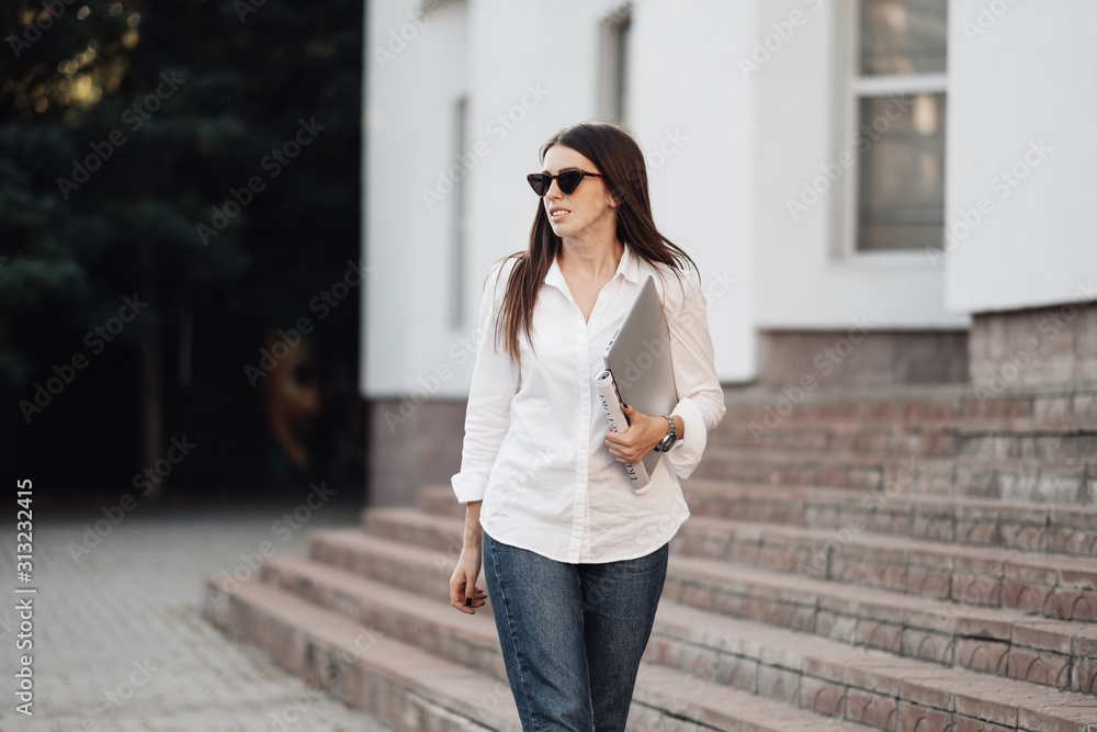 Portrait of One Fashionable Girl Dressed in Jeans and White Shirt Holding Laptop, Freelance Worker, Business Lady, Woman Power Concept
