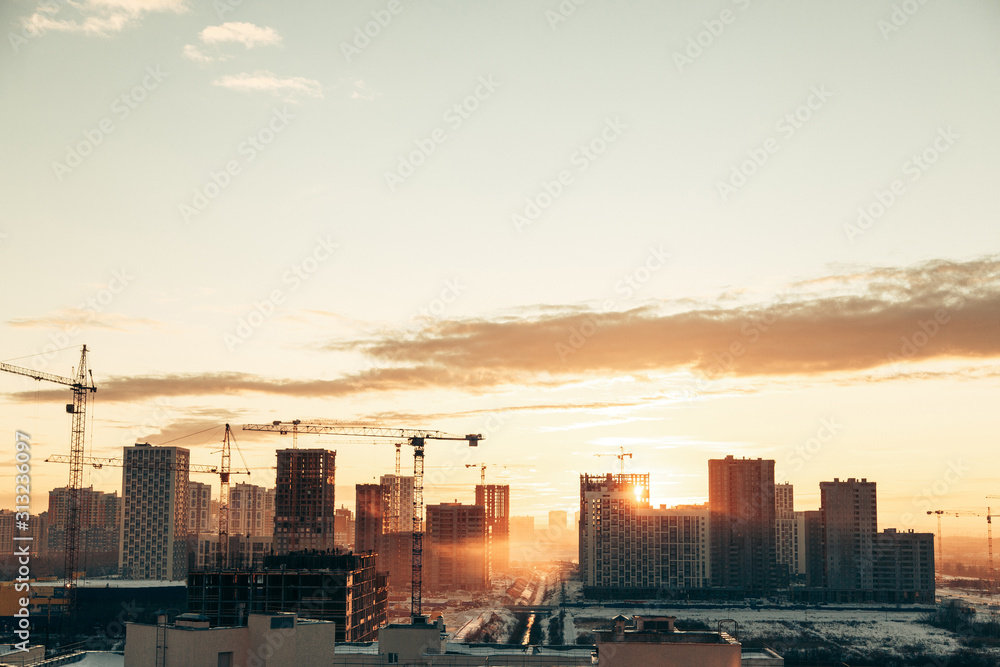 Panorama of construction at sunset. Construction of a residential complex with cranes. Panorama of construction at sunset. Construction of a residential complex with cranes.