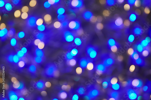 Christmas background. dark bokeh background. Blue lights blur. copyspace.