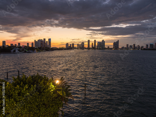 Downtown Miami sunset from the Venetian Islands (Florida). The most beautiful sunset ever. Delightful seascape with skyscrapers in the background. The night is coming, perfect lighting (orange color).
