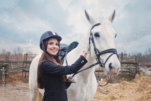Ride lesson. Young woman with horse outdoors