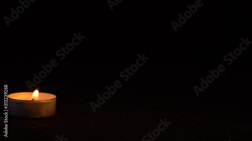 Slow motion white candles light up flames fire on isolated black background. Use in romantic dinner, warm and relax peace maditaion, use for spiritual religion church decotion and Halloween graveyard photo