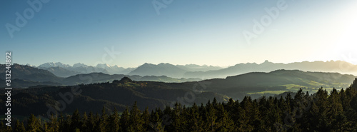 Tableau sur toile swiss mountain range in switzerland while the valley is covered in fog during su