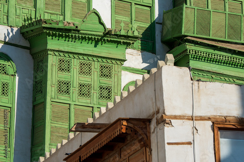 Close-up view of the greenish Noorwali coral town house at the Souk al Alawi Street in the historic city center of Al Balad, Jeddah, Saudi Arabia photo
