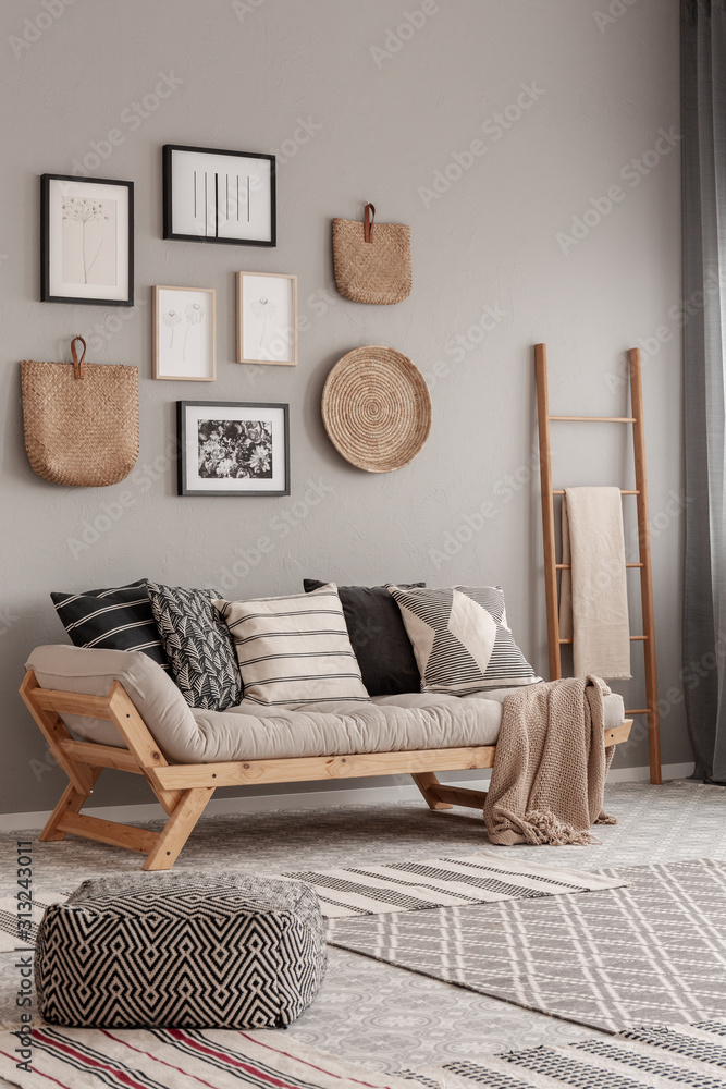 Beige scandinavian settee with patterned pillows in stylish living room interior - obrazy, fototapety, plakaty 