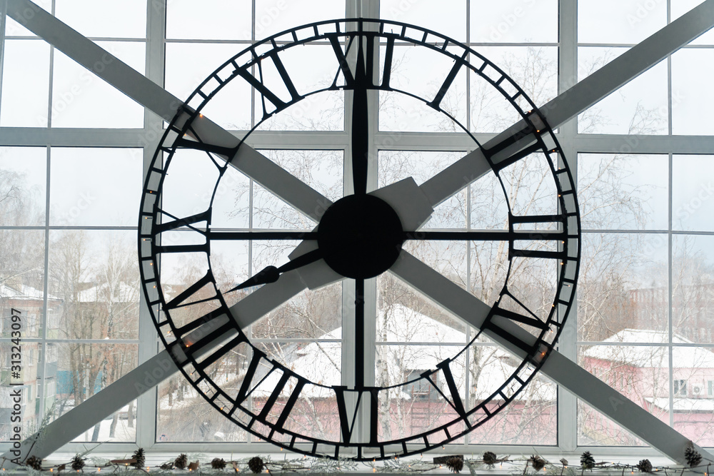 huge mechanical clock on the window in the room