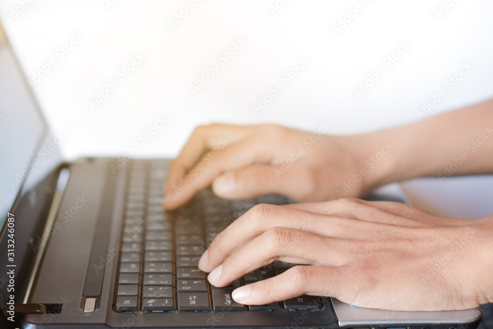 Two hands typing on laptop keyboard Two hands typing on laptop keyboard