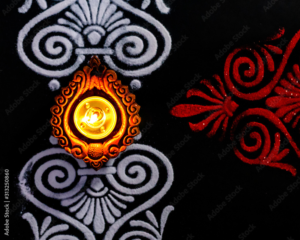 cropped close up of shining diya and rangoli art on black background.  diwali concept Stock Photo | Adobe Stock