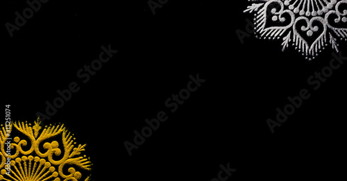 Photography top view of beautiful rangolis in corners on black background