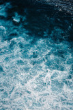 Aerial view to ocean waves. Blue water background.