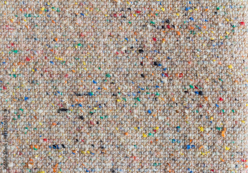 The texture of the costume fabric boucle with colored inclusions