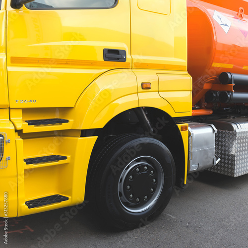 A heavy yellow-orange fuel tanker designed to carry fuel.