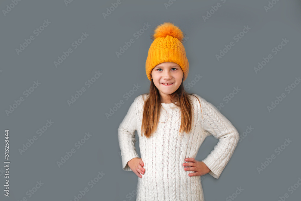 Funny caucasian child in knitted hat with pompom Funny caucasian child in knitted hat with pompom