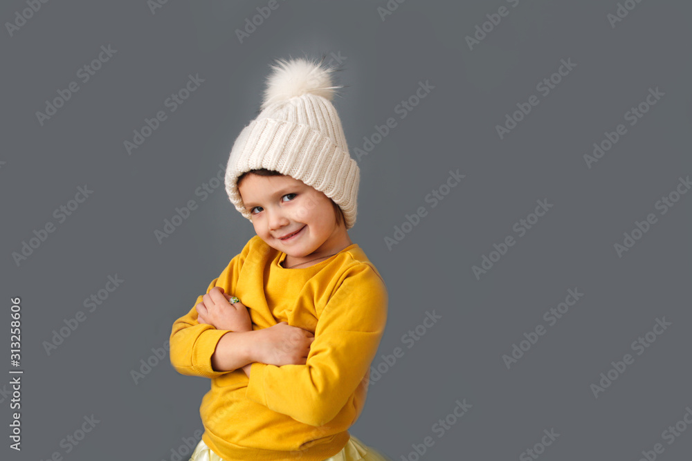 Funny caucasian child in knitted hat with pompom Funny caucasian child in knitted hat with pompom