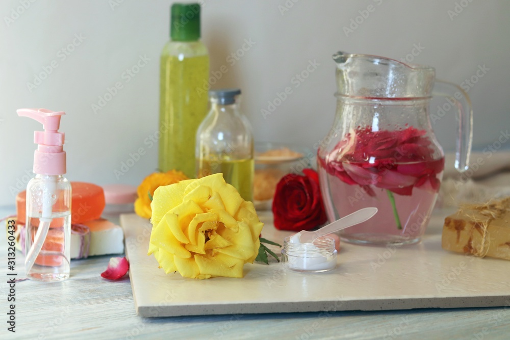 Fresh roses, petals, water and oil on the table for the preparation of natural cosmetics, spa treatments, healthy lifestyle Fresh roses, petals, water and oil on the table for the preparation of natural cosmetics, spa treatments, healthy lifestyle