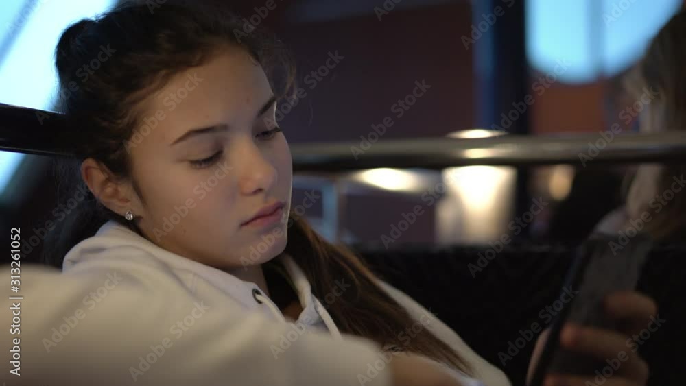 thoughtful girl in white sweater sits in cafe and reads messages on smartphone sailing by ferry extreme close view thoughtful girl in white sweater sits in cafe and reads messages on smartphone sailing by ferry extreme close view