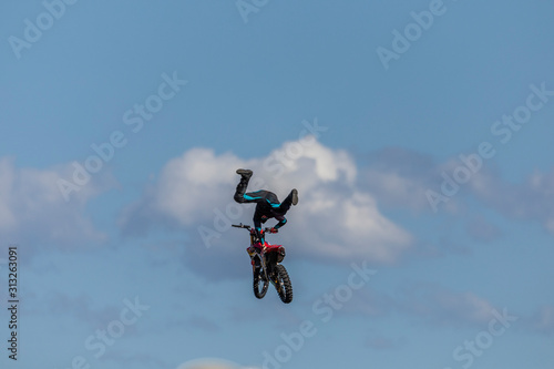 Stunt Motocross motorbike rider on a jump