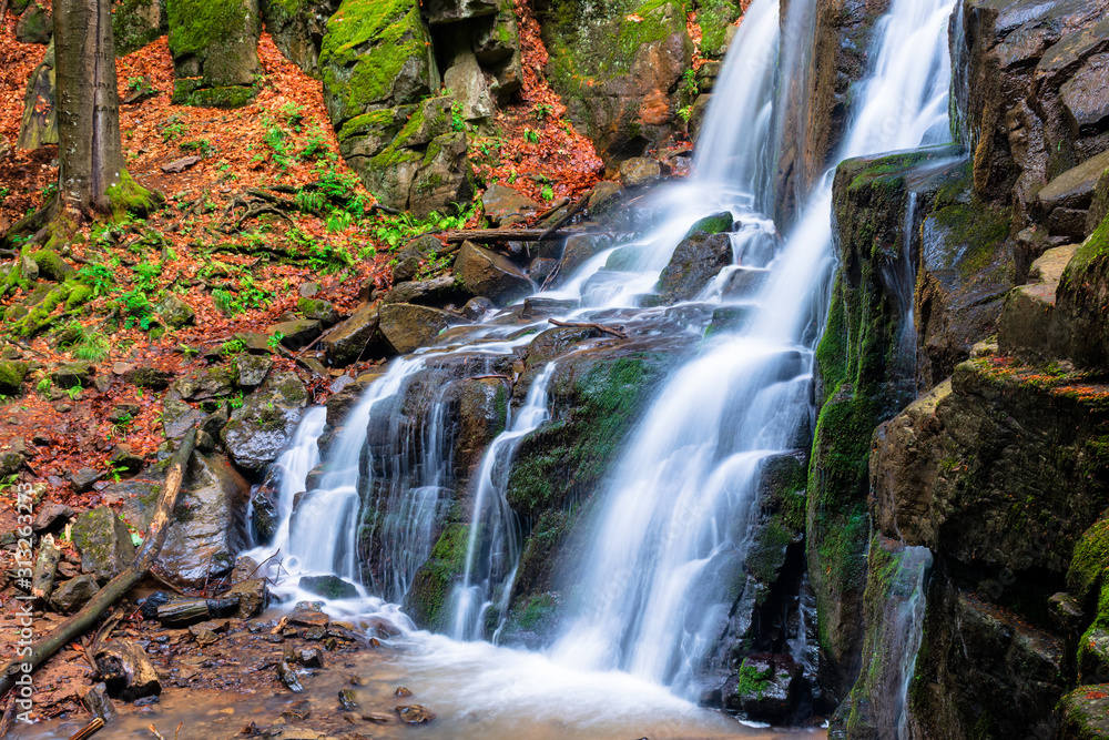waterfall skakalo in the forests of transcarpathia. rapid water stream runs down the huge boulders. clear water of carpathian nature in springtime. long exposure waterfall skakalo in the forests of transcarpathia. rapid water stream runs down the huge boulders. clear water of carpathian nature in springtime. long exposure