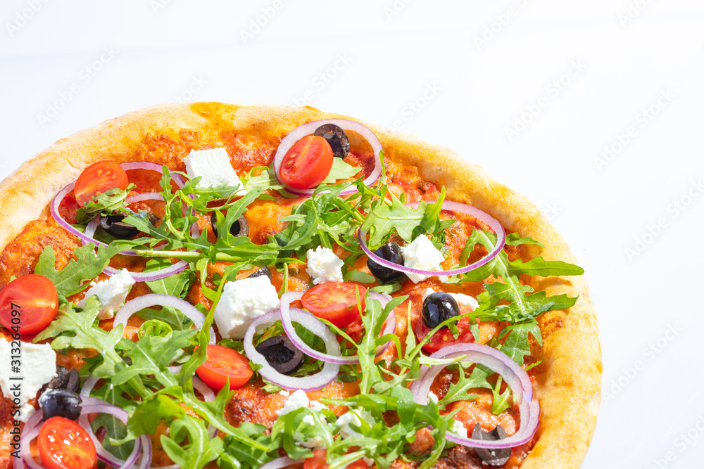 Italian hot pizza with tomato, arugula, cheese Feta, black olives and rings onion isolated on white background Italian hot pizza with tomato, arugula, cheese Feta, black olives and rings onion isolated on white background