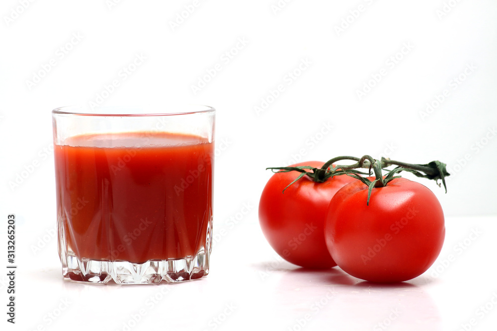 a glass of tomato juice and tomatoes isolated on white backgrond. Horizontal image a glass of tomato juice and tomatoes isolated on white backgrond. Horizontal image
