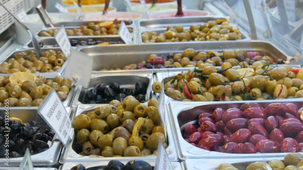A market counter with various stuffed olives of green, red, black. Vegetarian food A market counter with various stuffed olives of green, red, black. Vegetarian food