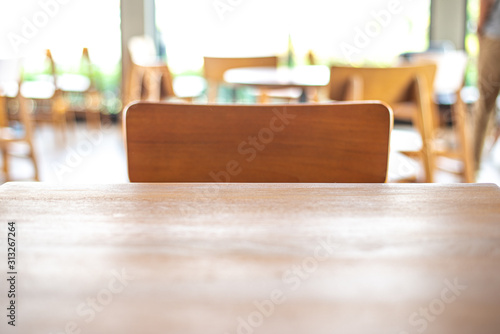 Empty wood table top on blurred background form coffee shop