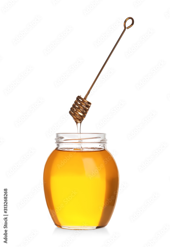 Honey dripping from dipper into jar isolated on white Honey dripping from dipper into jar isolated on white