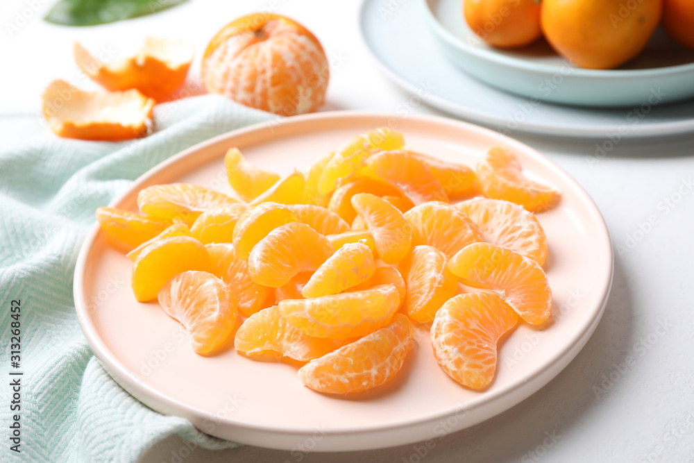 Segments of fresh ripe tangerines on white table Segments of fresh ripe tangerines on white table