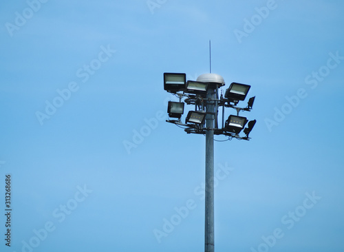 Street Public luminaire with lighting pole against a blue sky background. Spotlight tower on Expressway.