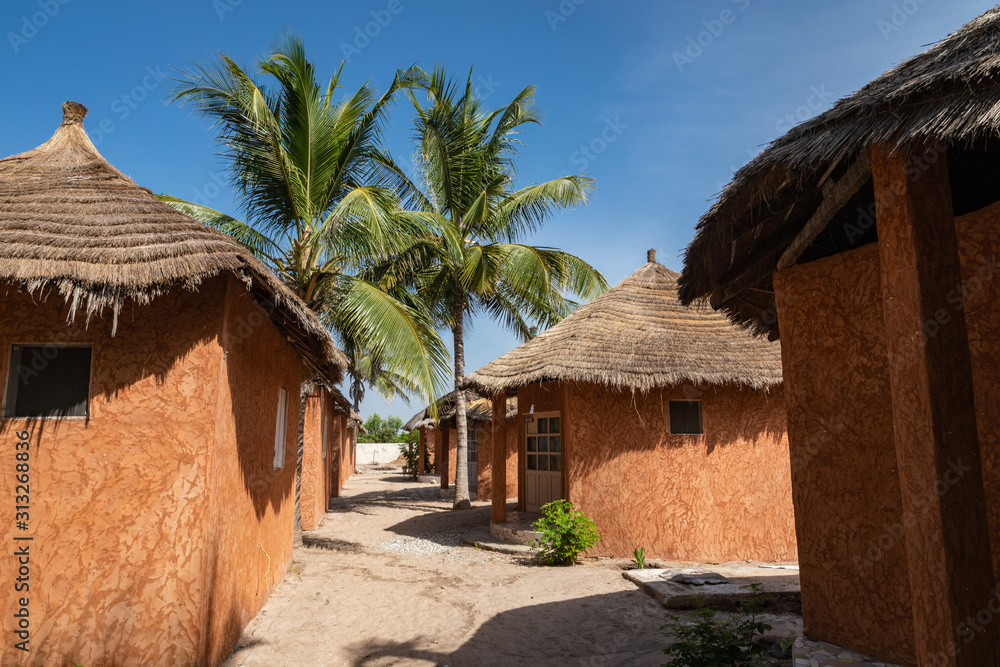 Traditional tourist resort in Senegal. Big green palms.