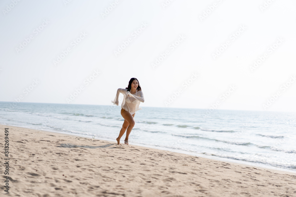 Women exercising in the morning on the beach during the holidays make the body healthy.