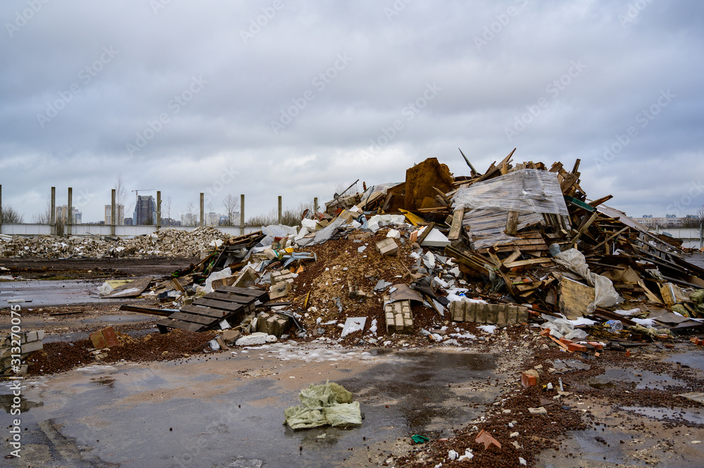 The concept of trash environmental disaster. Photo of a landfill on a street in a city on a cloudy day. The concept of trash environmental disaster. Photo of a landfill on a street in a city on a cloudy day.