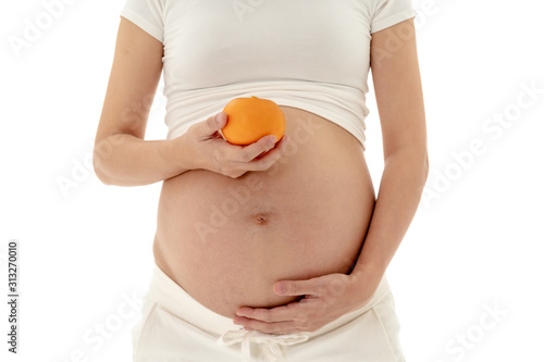 Asian Pregnant Woman Standing Holding Orange in Hand
