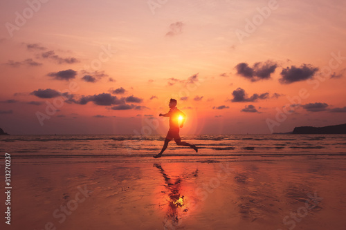 A man running at island and him running on the beach with sunset and beautiful sky with nice cloud.