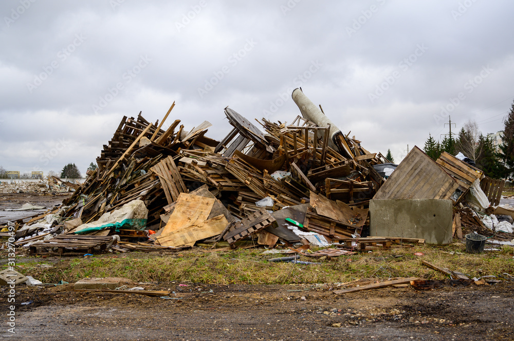 The concept of trash environmental disaster. Photo of a landfill on a street in a city on a cloudy day. The concept of trash environmental disaster. Photo of a landfill on a street in a city on a cloudy day.