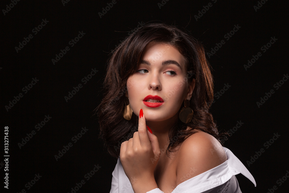 Beautiful woman with bright makeup posing isolated over black background. Beautiful woman with bright makeup posing isolated over black background.
