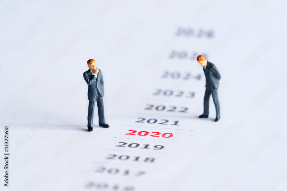 Year red 2020 and businessman standing on paper white background. concept for business vision and business strategy. success concept. Year red 2020 and businessman standing on paper white background. concept for business vision and business strategy. success concept.