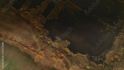 Small lake at Warmia-Masuria region in Poland at sunset. Drone, aerial footage. photo