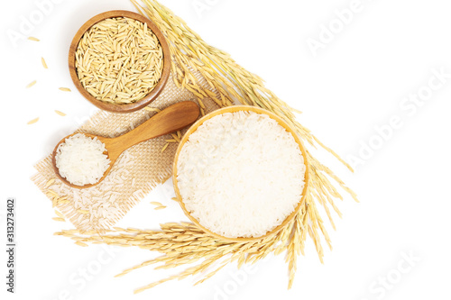 Top view of white Jasmine rice and paddy rice in wooden bowl and unmilled rice with Ear of rice isolated on white background with copy space
