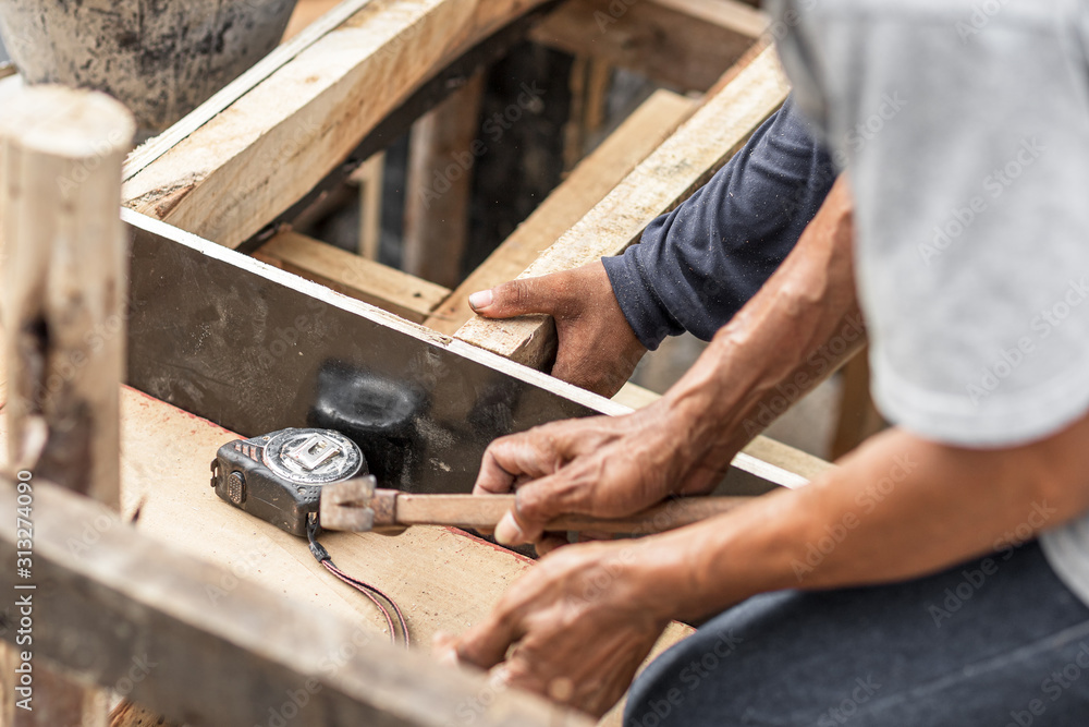 carpenter working at site construction. Measuring Tape on wood board. carpenter working at site construction. Measuring Tape on wood board.