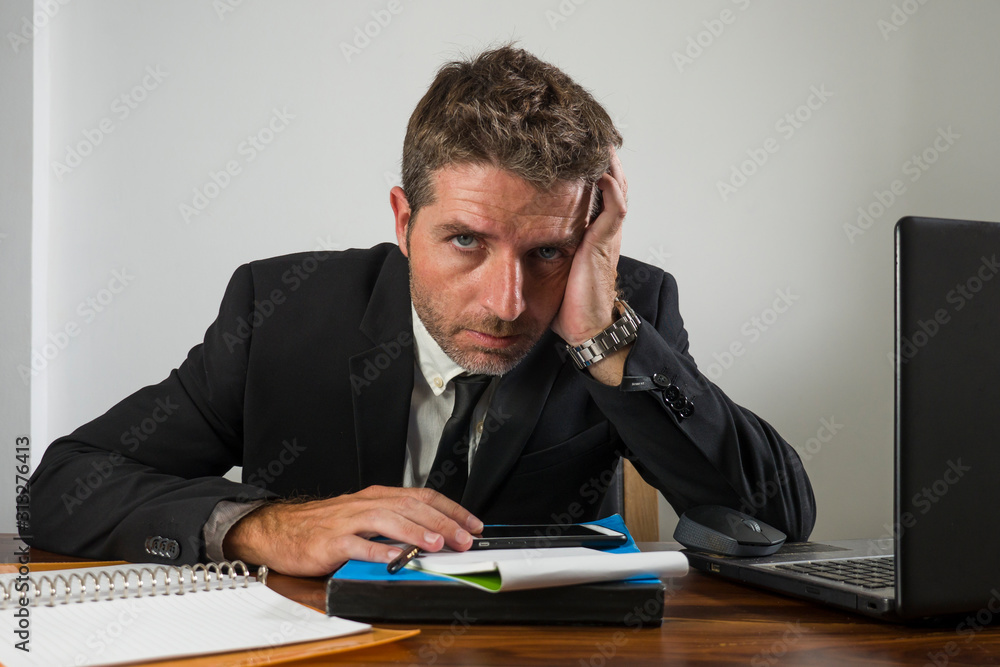young desperate and frustrated businessman working stressed and upset sitting at office computer desk serious feeling sad suffering depression young desperate and frustrated businessman working stressed and upset sitting at office computer desk serious feeling sad suffering depression