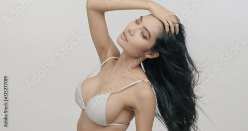 Very sexy woman posing in slow motion. Asian woman in bikini. Slow motion. Sexy woman health and beauty concept.