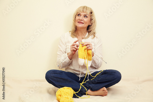 adult woman with yarn and knitting needles. leisure and hobbies in spare time. photo