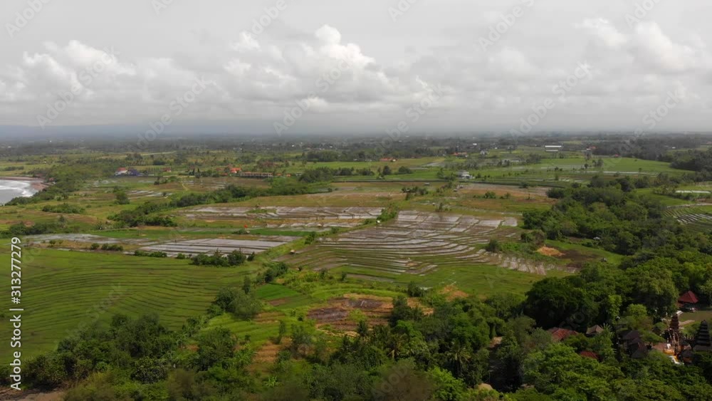 Aerial shot of landscape of rice fields near Pura Tanah Lot temple, Bali Indonesia. Cloudy weather. Aerial shot of landscape of rice fields near Pura Tanah Lot temple, Bali Indonesia. Cloudy weather.