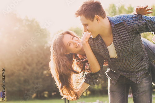 Lifestyle, happy couple of two play on a sunny day in the park