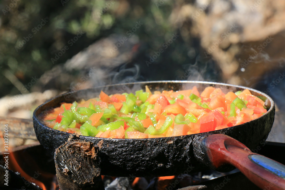 Frying tomatoes in nature