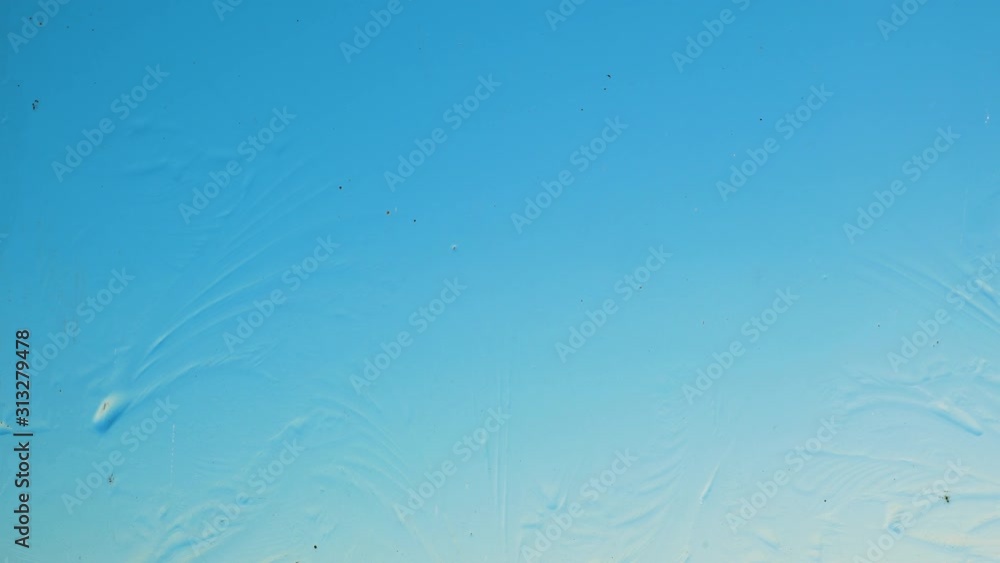 Winter patterns on the window pane are growing. Clear blue sky. Winter concept Winter patterns on the window pane are growing. Clear blue sky. Winter concept